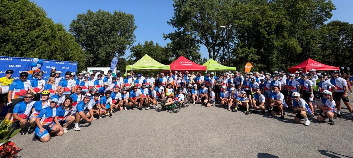 Group of cyclists riding through the roads of Joliette during the RIDE END ALS Québec 2025 to support research and families affected by ALS.